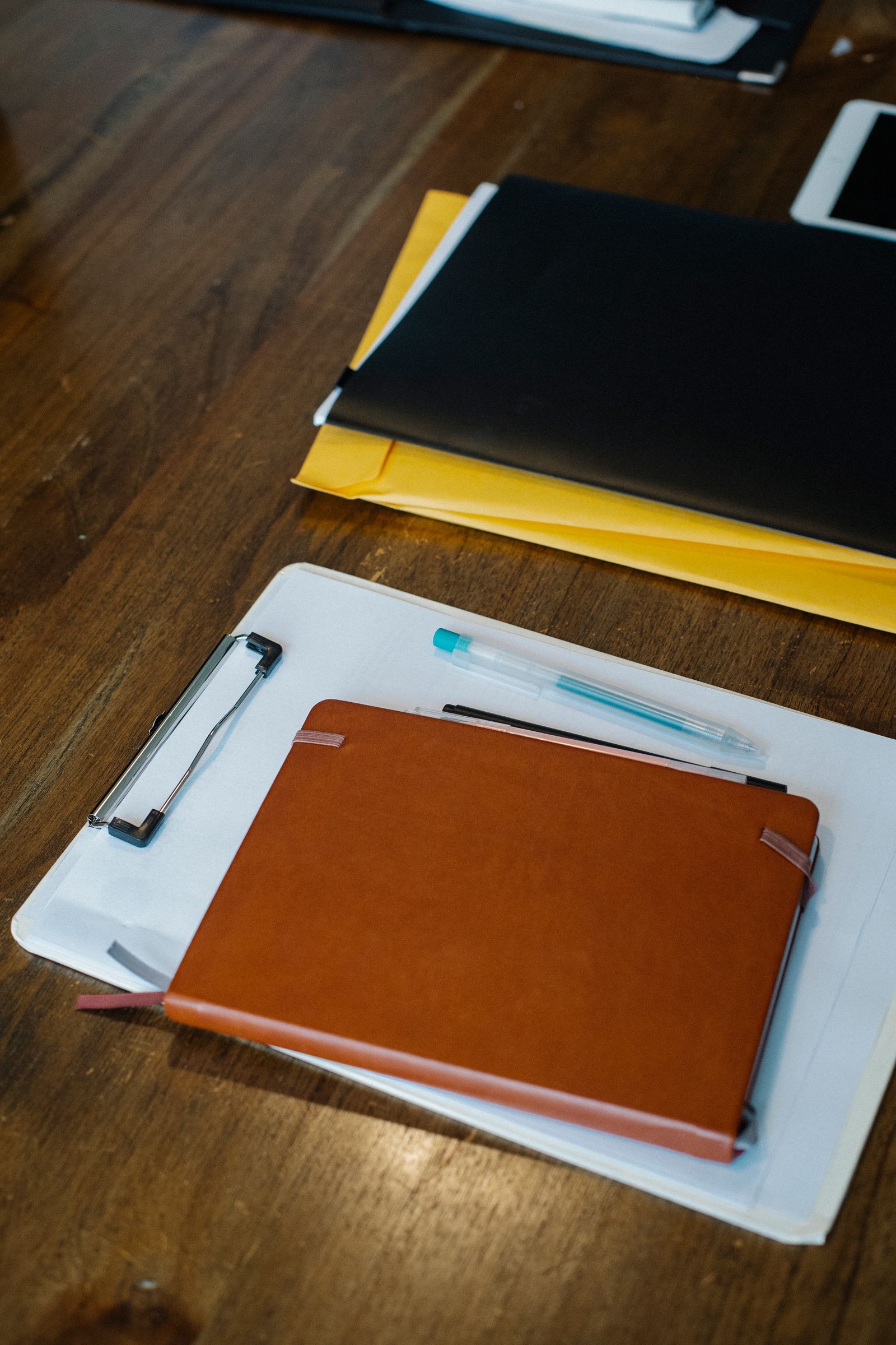 A landlord's paperwork — ledgers, folders, and pens on a desk