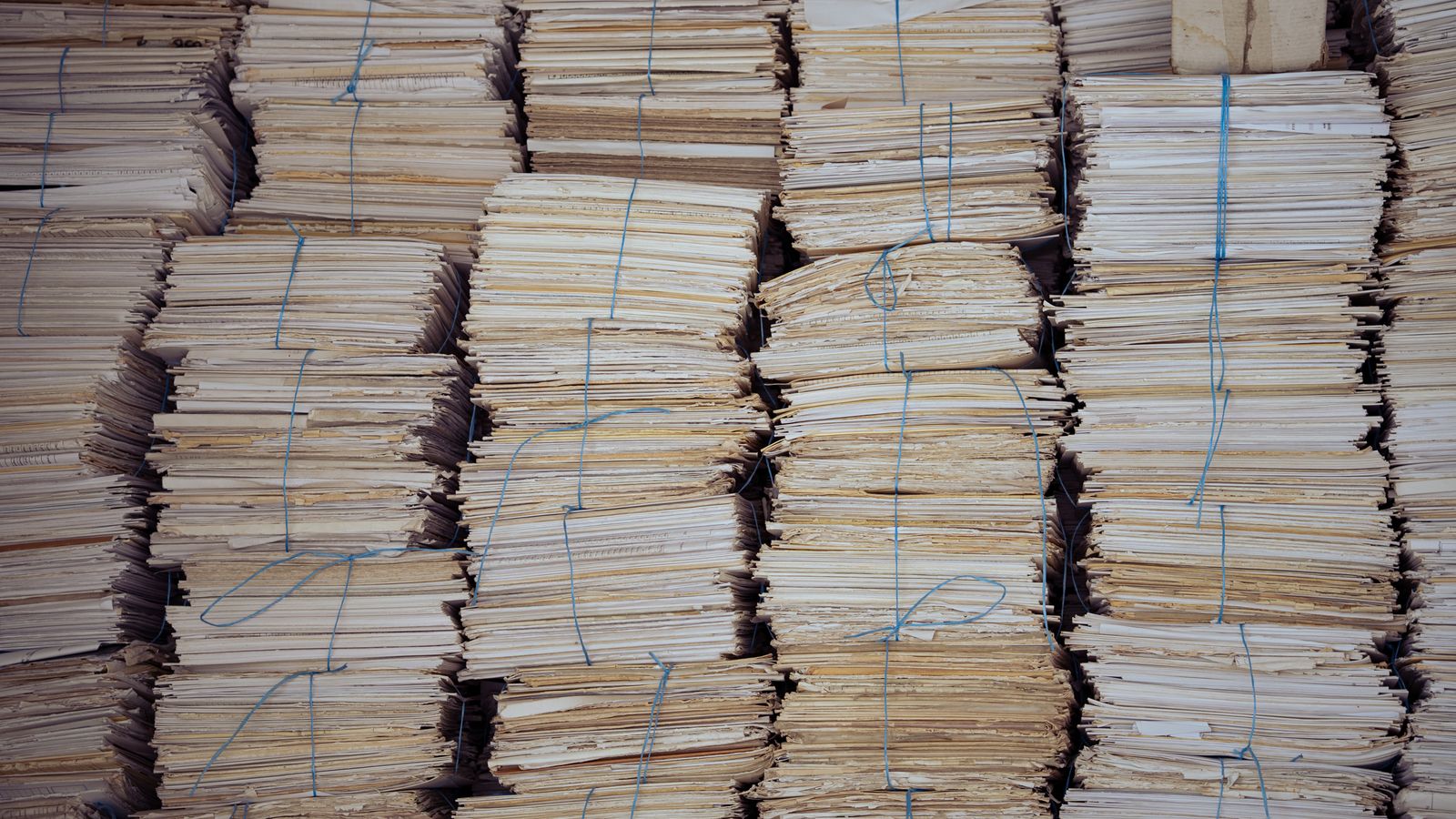 Bundled paper receipts tied with string — the padala-counter paper trail BHouse digitizes